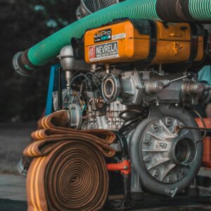 Detailed view of industrial pump with coiled hose, ideal for water and utility projects.