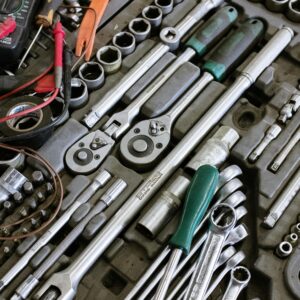 Detailed photo of various mechanic tools organized in a workshop setting. Perfect for repair themes.